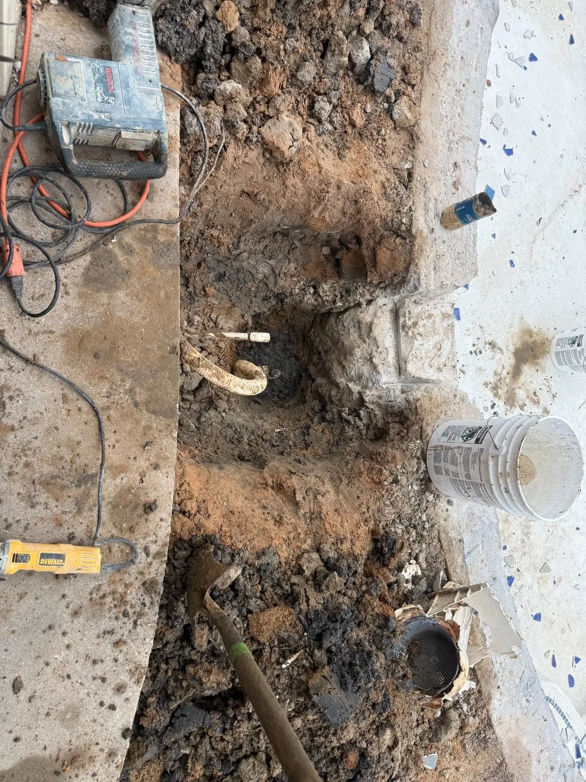 Pool deck excavation for underground plumbing repair