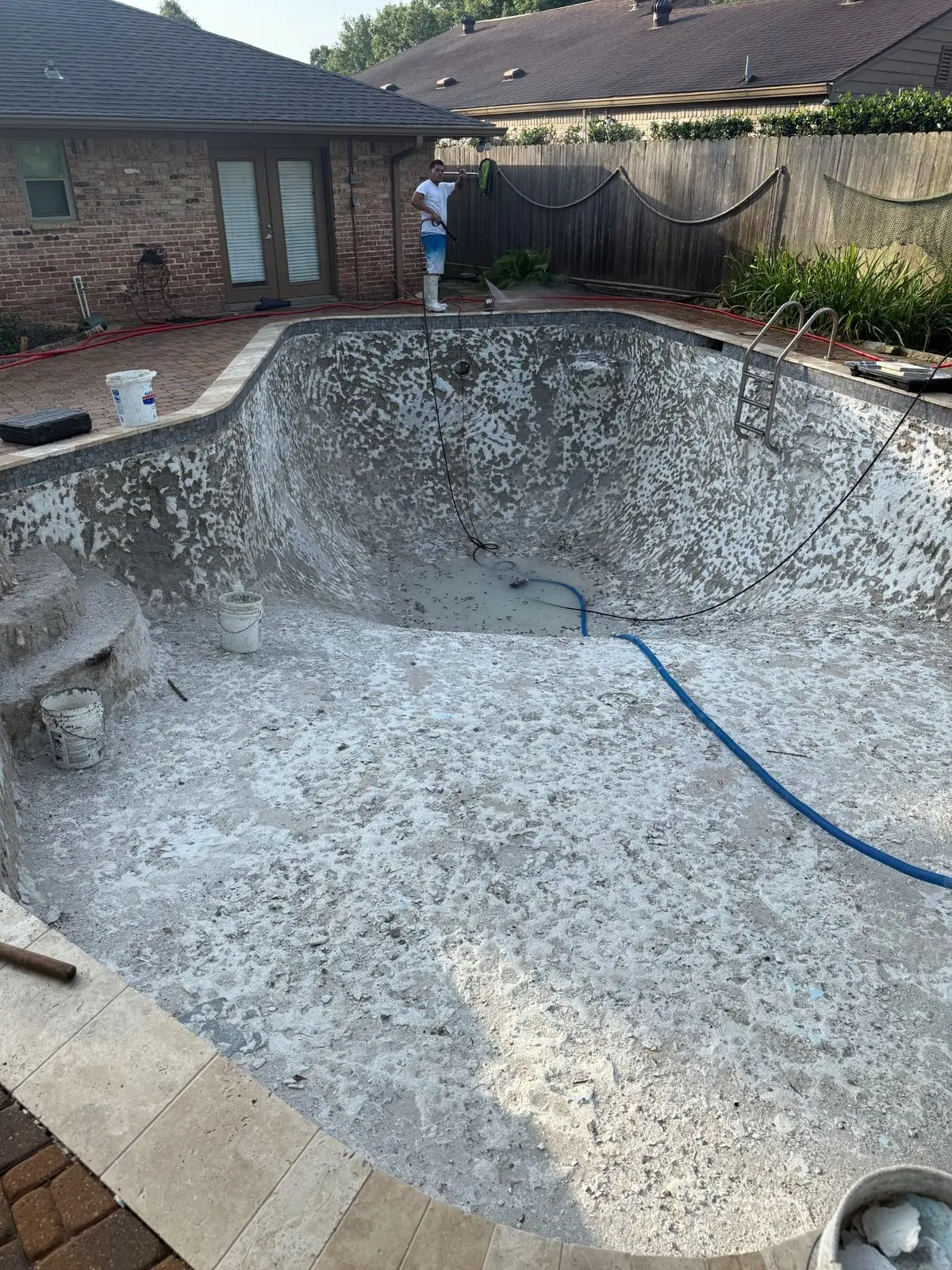 Swimming pool plaster removal and surface preparation before replastering