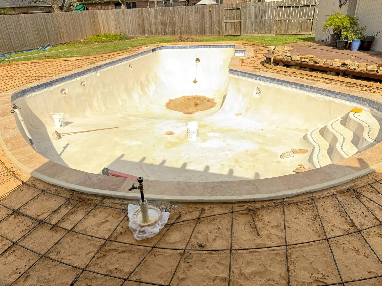 Pool renovation with deck rebar installation before concrete restoration