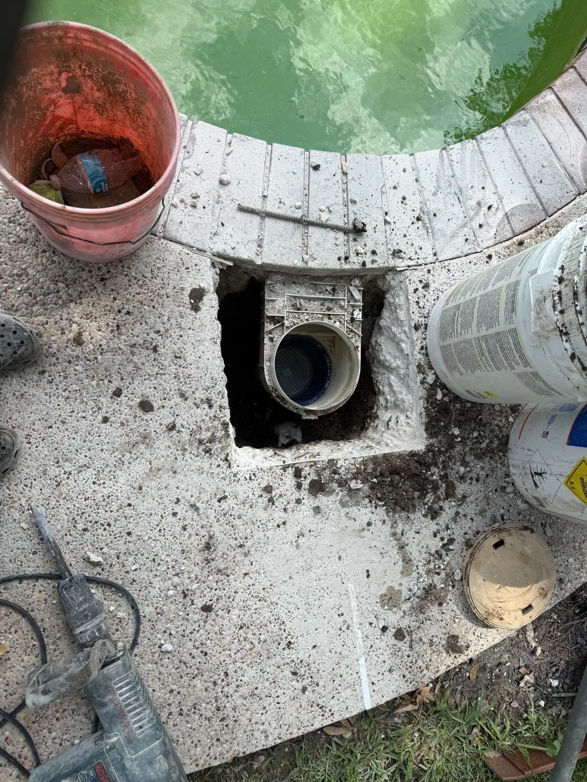 Swimming pool skimmer replacement installation in progress